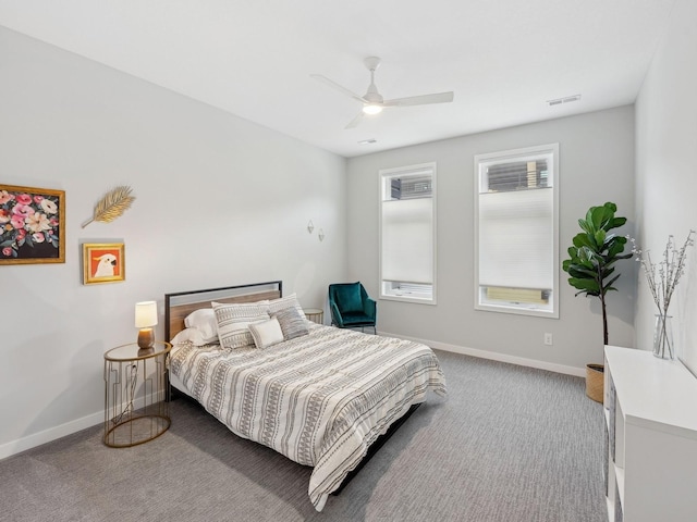 carpeted bedroom with baseboards, visible vents, and a ceiling fan