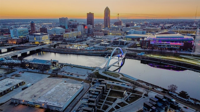 aerial view at dusk with a city view and a water view