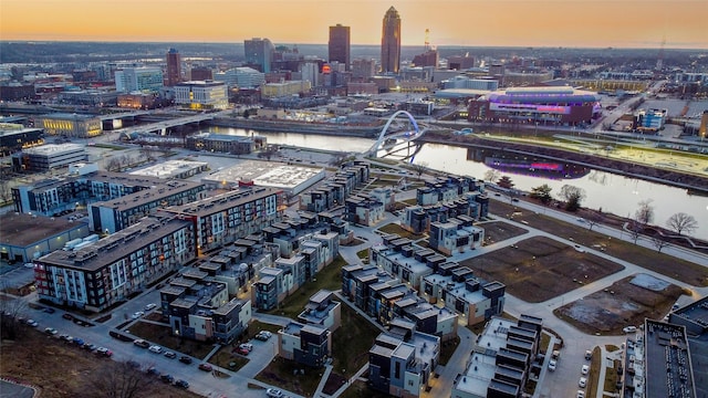 aerial view at dusk with a view of city and a water view