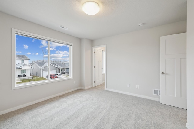 spare room with light colored carpet