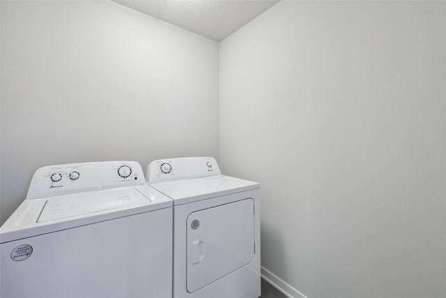 laundry room featuring washing machine and dryer and a textured ceiling