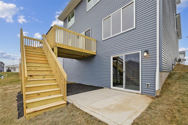 rear view of property with a patio area and a wooden deck