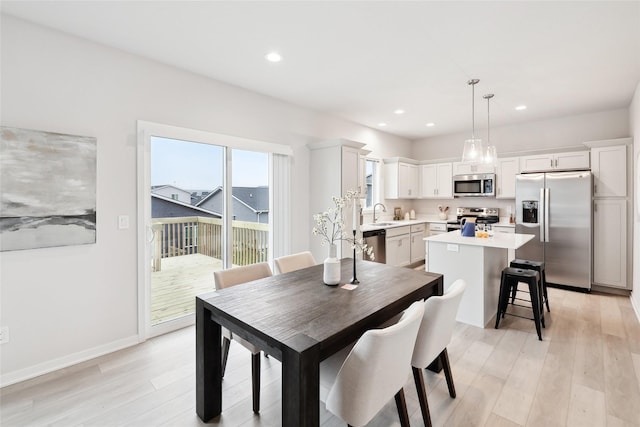 dining area featuring light hardwood / wood-style floors and sink