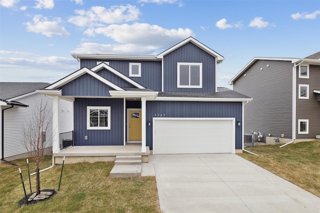 view of front of property featuring a front lawn, a porch, and a garage