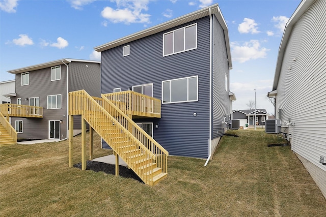 1727 Willow Ct, Norwalk, IA 50211 - back of house with stairs, a wooden deck, and a lawn