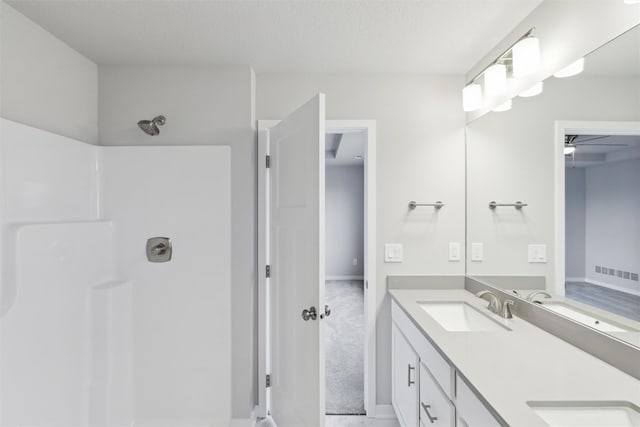 1727 Willow Ct, Norwalk, IA 50211 - bathroom featuring double vanity, a shower, and ceiling fan