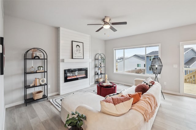 1727 Willow Ct, Norwalk, IA 50211 - living room featuring ceiling fan, wood finished floors, and a glass covered fireplace