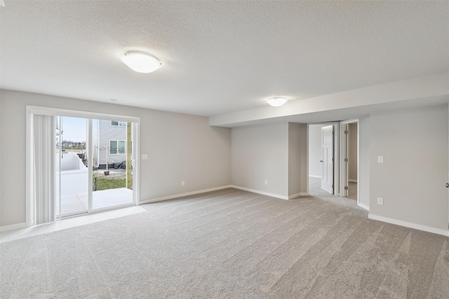 carpeted empty room with a textured ceiling