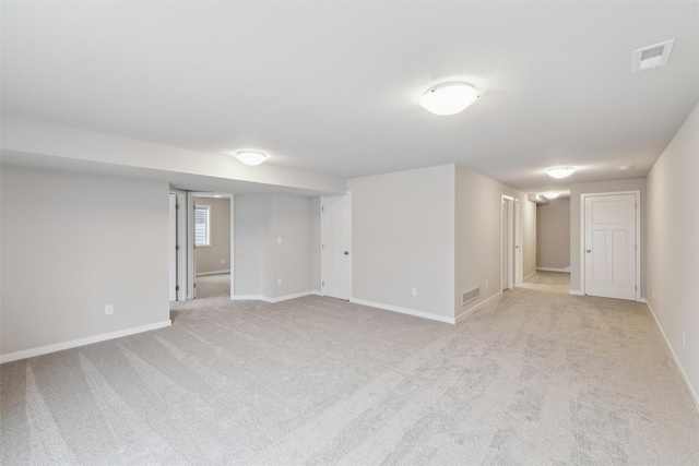 basement featuring light carpet