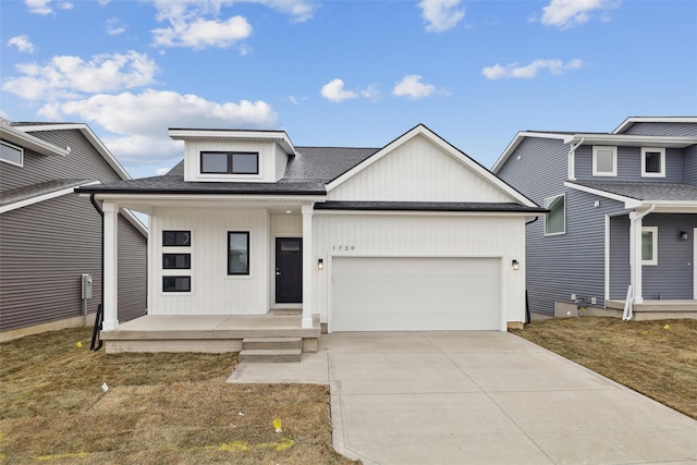 view of front of home featuring a porch and a garage