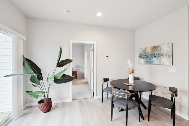 dining area with light hardwood / wood-style floors