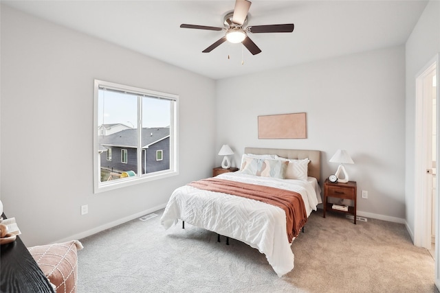 bedroom with ceiling fan and light carpet