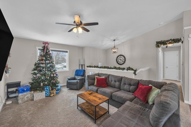 living room with vaulted ceiling, carpet floors, and ceiling fan with notable chandelier