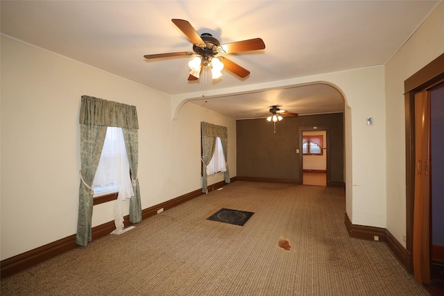 empty room featuring carpet flooring and ceiling fan