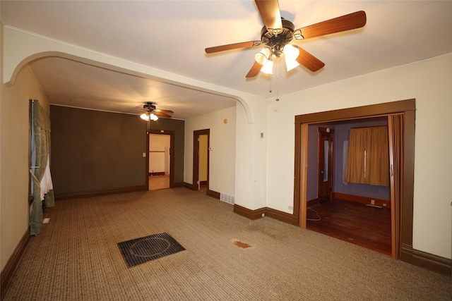 empty room featuring dark colored carpet and ceiling fan