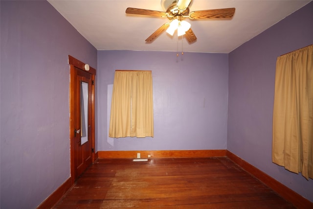 empty room featuring ceiling fan and dark hardwood / wood-style floors