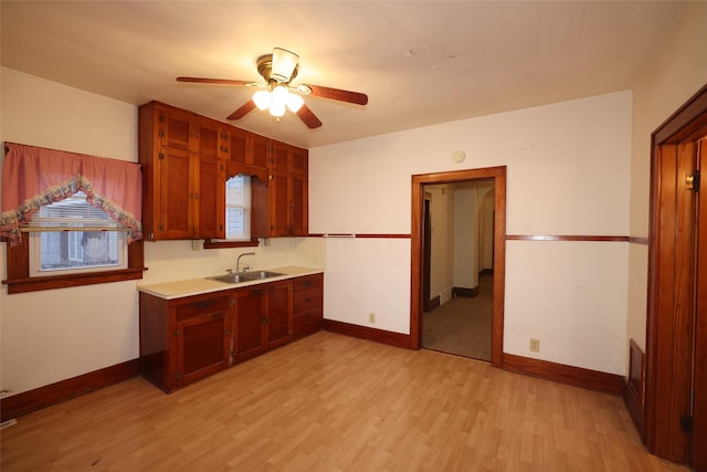 kitchen with light hardwood / wood-style flooring, ceiling fan, a healthy amount of sunlight, and sink