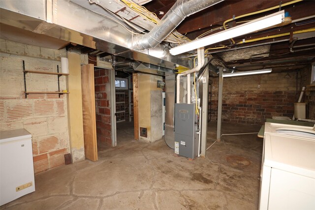 basement featuring refrigerator and heating unit