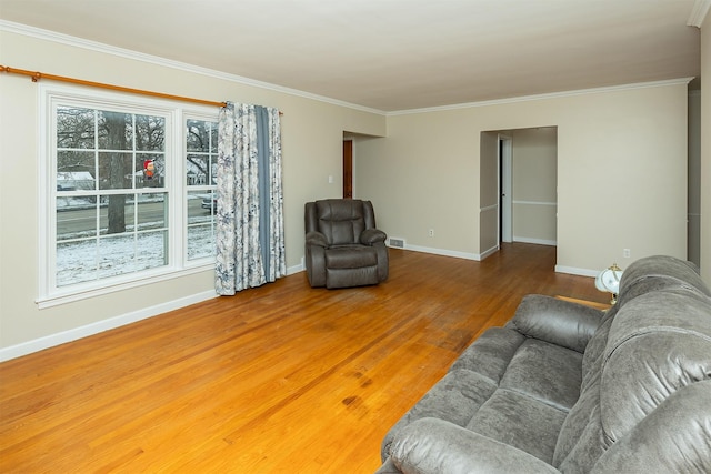 living room featuring wood-type flooring and ornamental molding