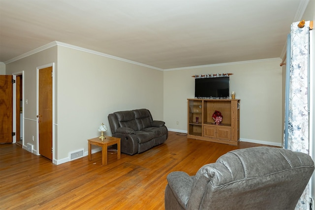 living room with light hardwood / wood-style floors and ornamental molding