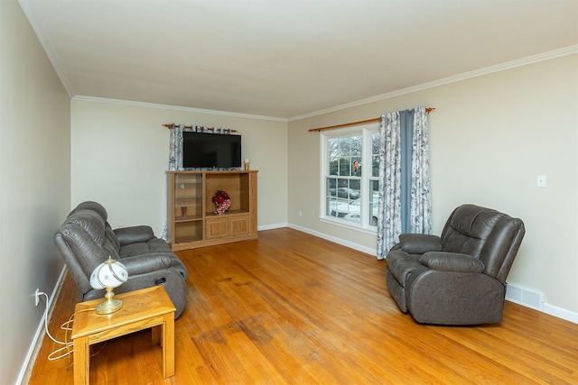 living room featuring wood-type flooring and ornamental molding