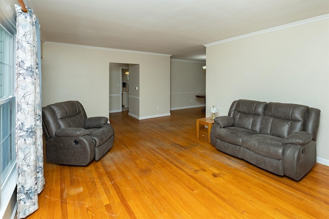 living room featuring hardwood / wood-style floors and crown molding