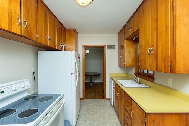 kitchen with light tile patterned flooring, white appliances, and sink