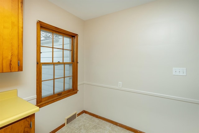 unfurnished dining area featuring light tile patterned floors