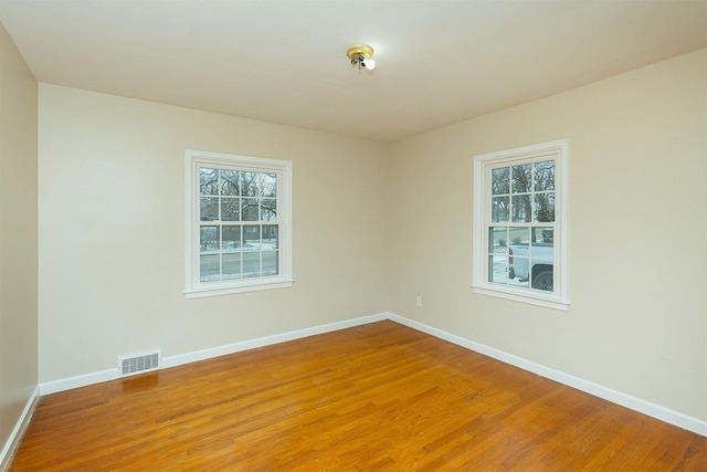 spare room with hardwood / wood-style floors