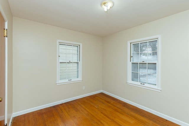 spare room with wood-type flooring