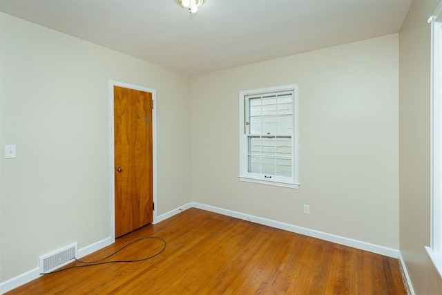 spare room with wood-type flooring