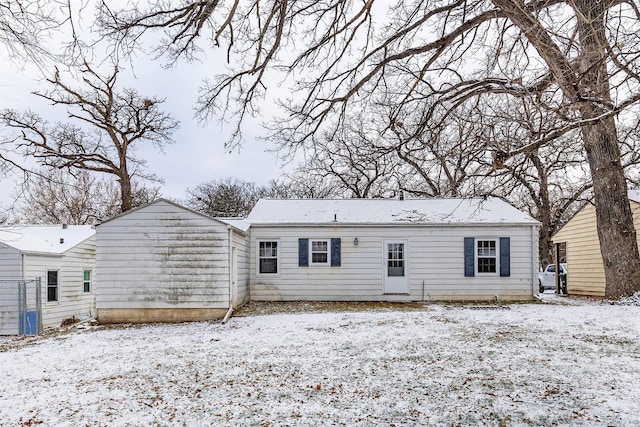 view of snow covered back of property