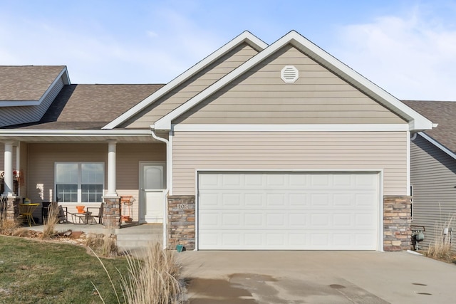 craftsman house featuring a porch and a garage