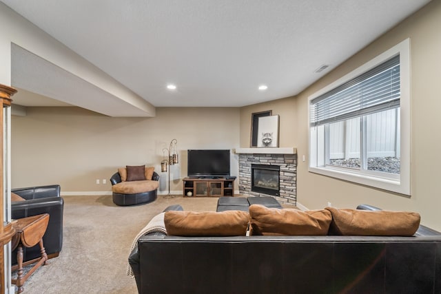 living room with carpet flooring and a stone fireplace