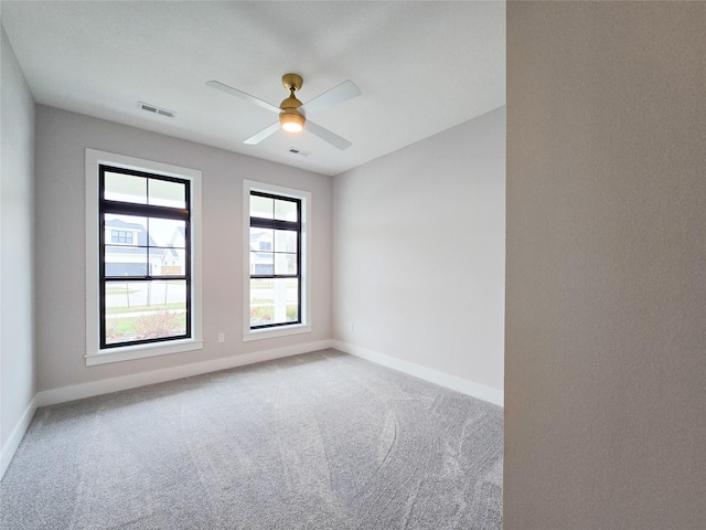 unfurnished room with carpet and ceiling fan