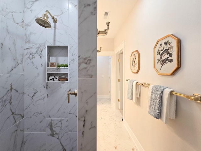 bathroom with a tile shower