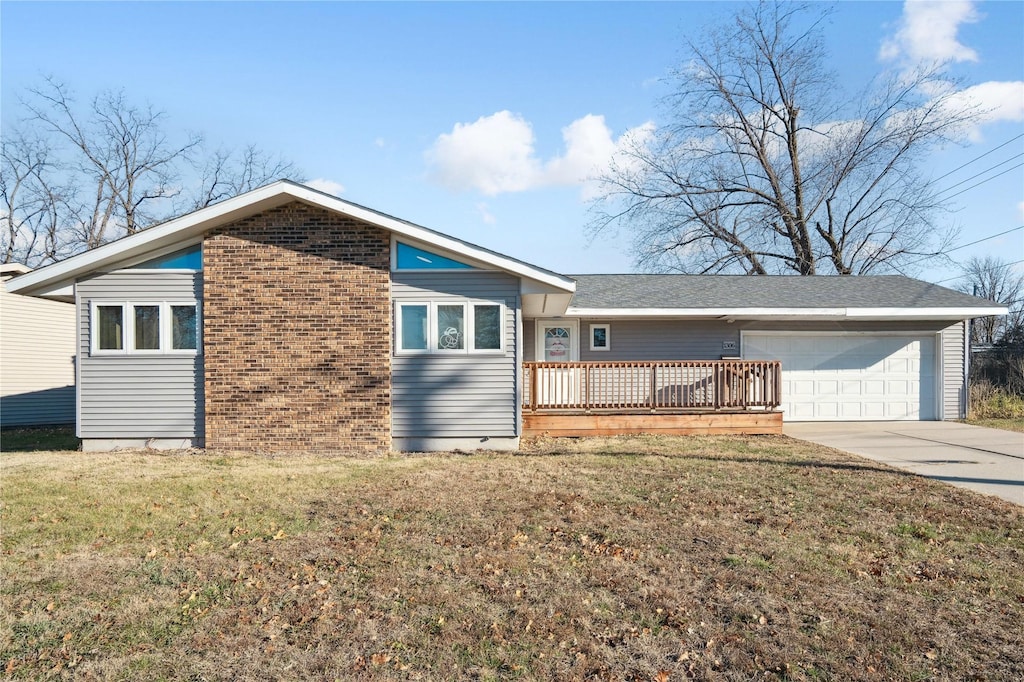 ranch-style house with a garage and a front lawn