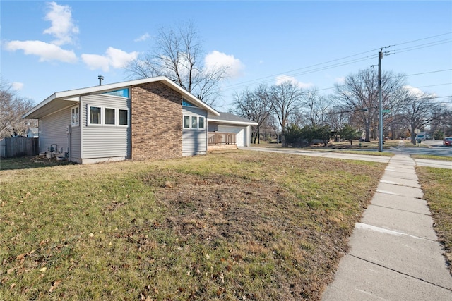 view of side of property featuring a yard