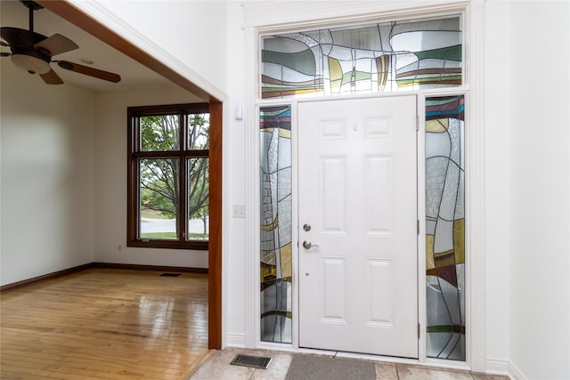 foyer with ceiling fan and light wood-type flooring