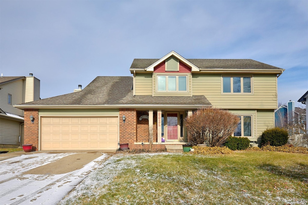 view of front of house with a garage and a front yard