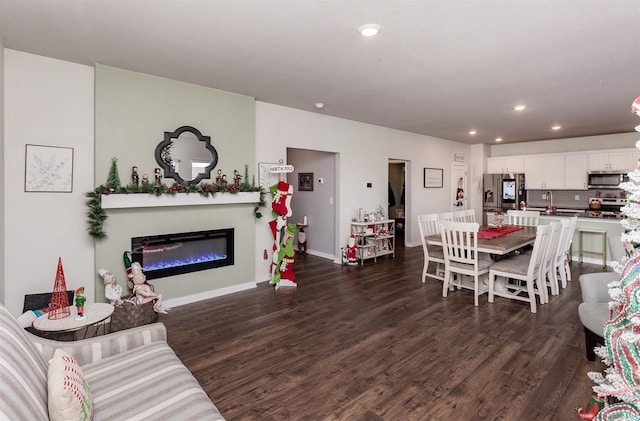 living room featuring sink and dark wood-type flooring