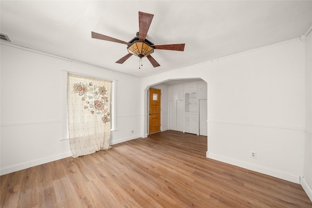 spare room with ceiling fan and wood-type flooring