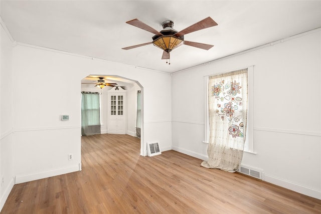 spare room featuring ceiling fan, light hardwood / wood-style floors, and crown molding