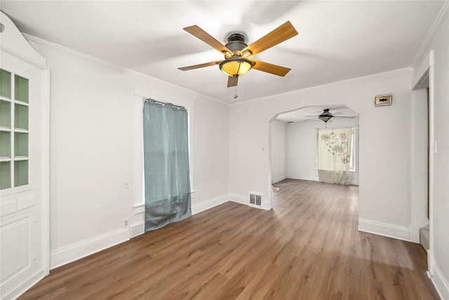 spare room featuring hardwood / wood-style flooring, ceiling fan, and crown molding