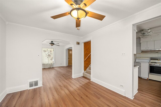 interior space featuring ornamental molding and light wood-type flooring