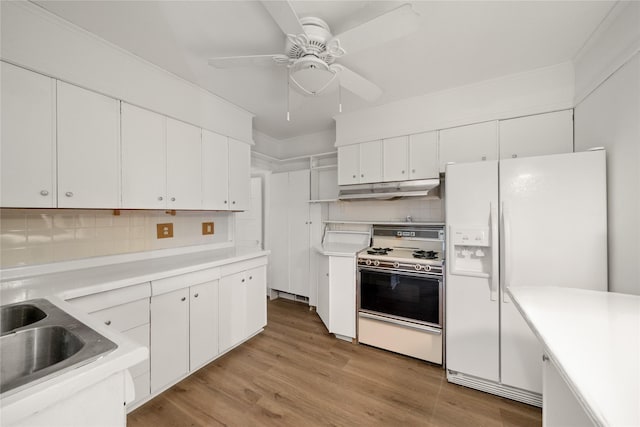 kitchen featuring range, white cabinetry, and white fridge with ice dispenser