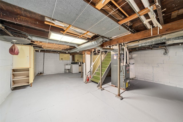 basement with washer / clothes dryer and heating unit