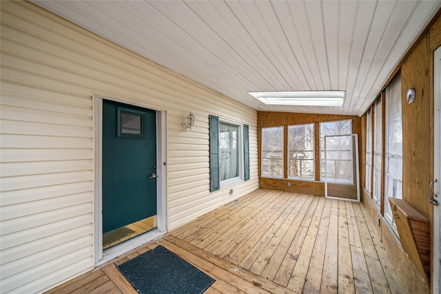 unfurnished sunroom featuring wood ceiling and lofted ceiling