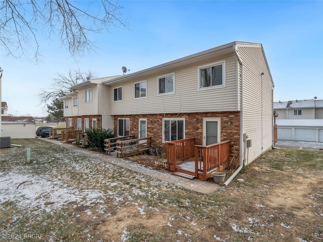 rear view of property featuring central AC