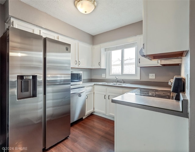 kitchen featuring white cabinetry, sink, stainless steel appliances, dark hardwood / wood-style flooring, and a textured ceiling